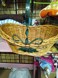 Wicker Basket with Green Metal Handle and Leaf Design - Image 1