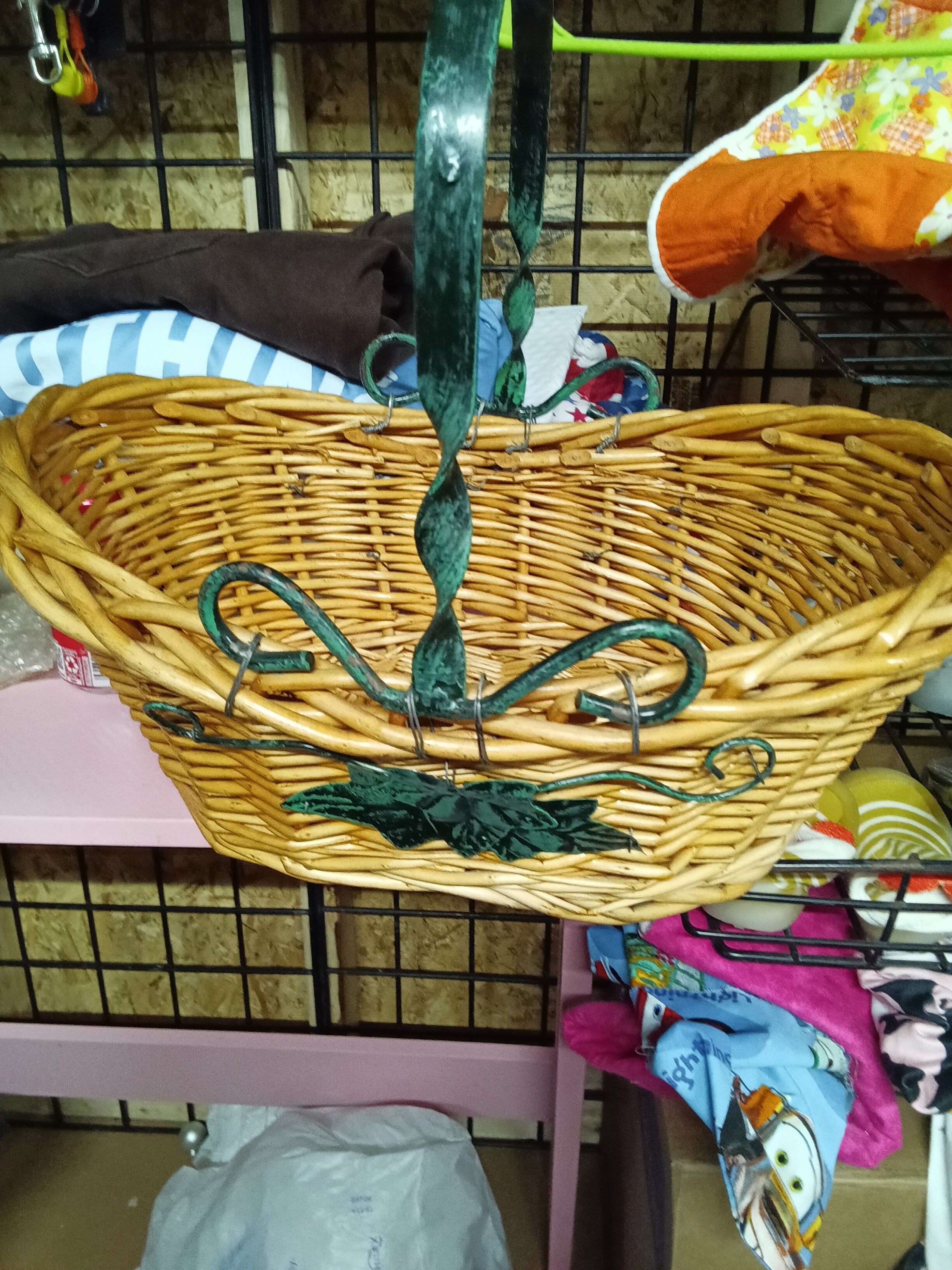 Wicker Basket with Green Metal Handle and Leaf Design - Image 1
